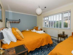 a bedroom with two beds and a window at See The Sea in Hunstanton