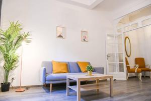 salon z niebieską kanapą i stołem w obiekcie Vieux-Port Grand appartement 2 ch avec terrasse w Marsylii