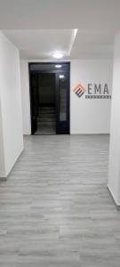 an empty hallway in an office with a sign on the wall at Apartman Ema in Valjevo