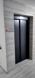 a black elevator in a room with a wall at Apartman Ema in Valjevo