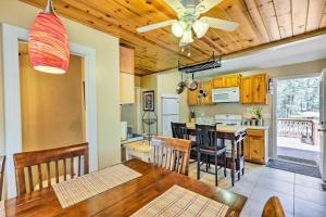 a dining room and kitchen with a table and chairs at Cozy Lakeside Escape with Deck 4 Mi to Rainbow Lake in Pinetop-Lakeside