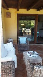 a living room with two chairs and a table at Sunny House a Punta Molara in San Teodoro