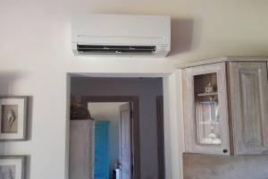 a living room with a white air conditioner on the ceiling at Sunny House a Punta Molara in San Teodoro +36 photos