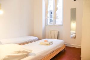 En eller flere senge i et værelse på Appartement 2 chambres Vieux Port et Cours Julien
