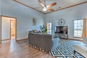a living room with a couch and a flat screen tv at Pet-Friendly Tecumseh Vacation Rental! in Shawnee