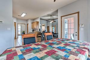 a bedroom with a colorful quilt on a bed at Pet-Friendly Tecumseh Vacation Rental! in Shawnee