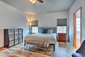 a bedroom with a bed and a dresser and windows at Pet-Friendly Tecumseh Vacation Rental! in Shawnee