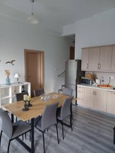 a kitchen with a wooden table and chairs in a room at Poros Seaside Suite in Poros