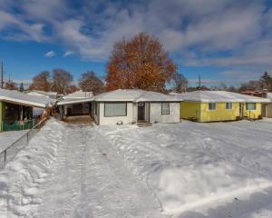 a snow covered driveway in front of a house at Adorable 2 BD 1 BTH Home Minutes Away from Gonzaga in Spokane