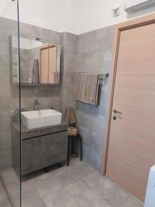 a bathroom with a sink and a mirror at Poros Seaside Suite in Poros