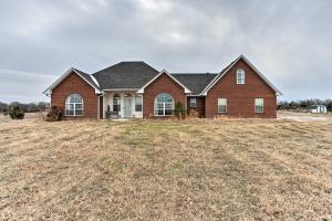 a brick house in a field of grass at Pet-Friendly Tecumseh Vacation Rental! in Shawnee