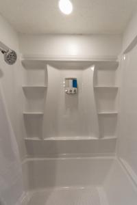 a bathroom with white shelves in a shower at Adorable 2 BD 1 BTH Home Minutes Away from Gonzaga in Spokane