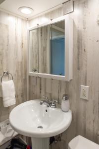 a bathroom with a sink and a mirror and a toilet at Adorable 2 BD 1 BTH Home Minutes Away from Gonzaga in Spokane