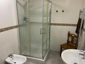a bathroom with a glass shower and a sink at Casa Alora in Alora