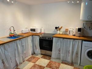 a kitchen with a sink and a dishwasher at Casa Alora in Alora