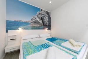 a bedroom with a bed with a view of the ocean at Villa Fina in Tučepi