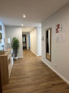 a hallway of an office with a desk and a mirror at Deluxe Bay View in Câmara de Lobos