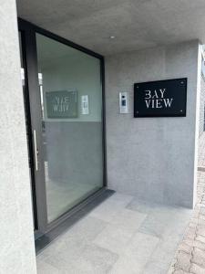 a glass door to a pay view sign on a building at Deluxe Bay View in Câmara de Lobos