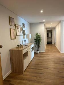 a room with a hallway with a desk and a plant at Deluxe Bay View in Câmara de Lobos