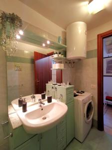 ein Badezimmer mit einem Waschbecken und einer Waschmaschine in der Unterkunft Colosseo Home - 29061 in Rom