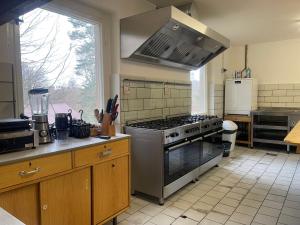 a kitchen with a stove top oven in a kitchen at Ferienheim Mosbach in Wutha-Farnroda