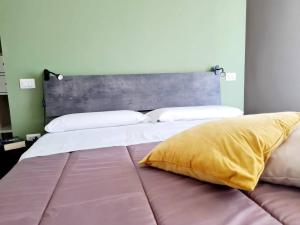 a large bed with a large headboard in a bedroom at Hiera' in Lecce