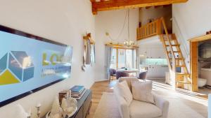 a living room with a large tv on a wall at Abitaziun Cravunera - Sils Maria in Sils Maria