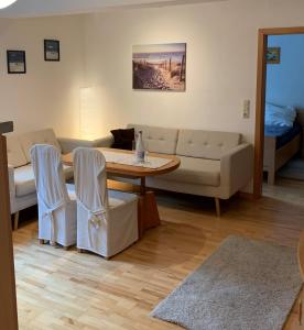 a living room with a table and a couch at Apartment close to the center + free parking in Oldenburg