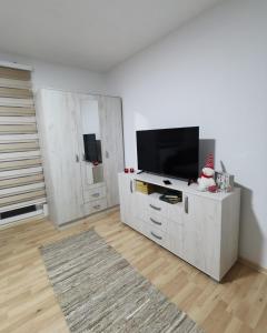 a living room with a television and a white cabinet at Midori Zlatar in Nova Varoš