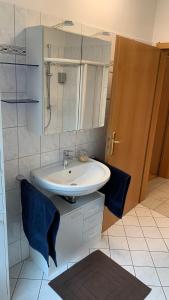 a bathroom with a sink and a mirror at Apartment close to the center + free parking in Oldenburg