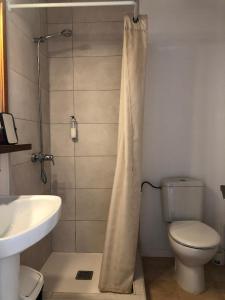 a bathroom with a shower with a toilet and a sink at Nure Mar y Mar in Cala en Blanes