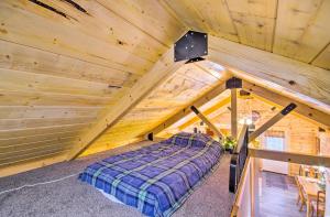 a bedroom in a log cabin with a bed at Florence Cabin with On-Site Creek! in Florence