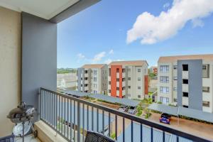 a balcony with a view of buildings at Cosy Butterfly Comforts 2 Bed Top Floor Unit in Fourways