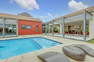 a swimming pool in the backyard of a house at Cosy Butterfly Comforts 2 Bed Top Floor Unit in Fourways