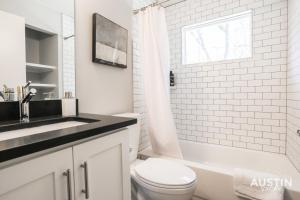 a white bathroom with a sink and a toilet at Bright Space Close To Best Beer Gardens Coffee in Austin +19 photos