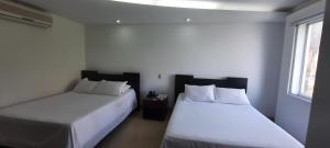Postel nebo postele na pokoji v ubytování Hotel Mediterraneo