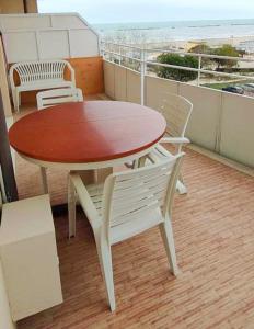 a table and chairs on a balcony with the beach at La terrazza sul mare in Cesenatico