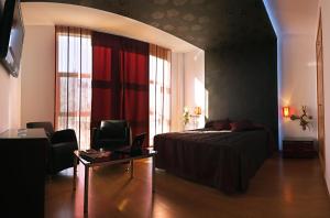 1 dormitorio con 1 cama, 1 mesa y 1 silla en Noriega, en Pozoblanco