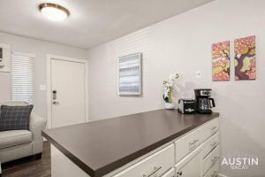 a kitchen with a counter top in a room at Walk To Zilker King Bed Pool Free Parking in Austin
