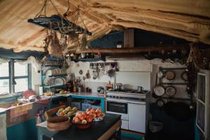 a kitchen with a stove and a bowl of fruit on a counter at El Carmen in Ribera Alta