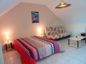 a small bedroom with a bed and a couch at Résidence Au Soleil Breton Pentrez in Pentrez