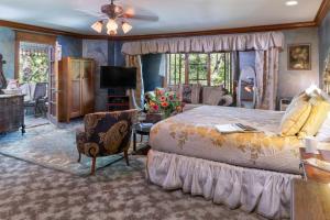 a bedroom with a large bed and a living room at Angel at Rose Hall in Eureka Springs