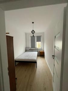 Posteľ alebo postele v izbe v ubytovaní Apartament Piesza