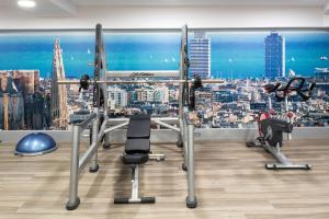 a gym with a view of a city at Catalonia Sagrada Familia in Barcelona
