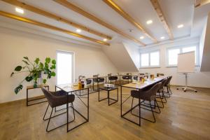a large room with tables and chairs in it at Hotel & Boarding House Schlosserwirt in Mering