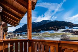 a view from a cabin balcony with snow covered mountains at SciliarGuestHouse-due piani parcheggio privato in Castelrotto