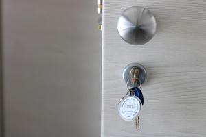a key to a door with a keyring on it at PIUMABLU in Campi Bisenzio
