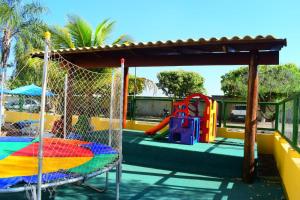 a playground with a colorful slide and a swing at Locação Caldas Novas 1105 in Caldas Novas