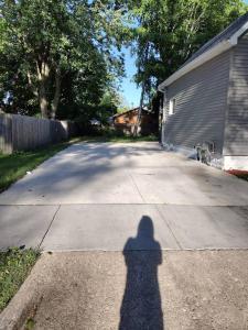 a shadow of a person standing on a driveway at Modern home on city's westside in Bay City