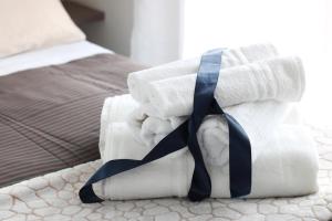 a pile of rolled up towels on a bed at PIUMABLU in Campi Bisenzio
